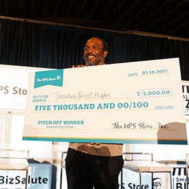 Smiling male holding poster-sized check